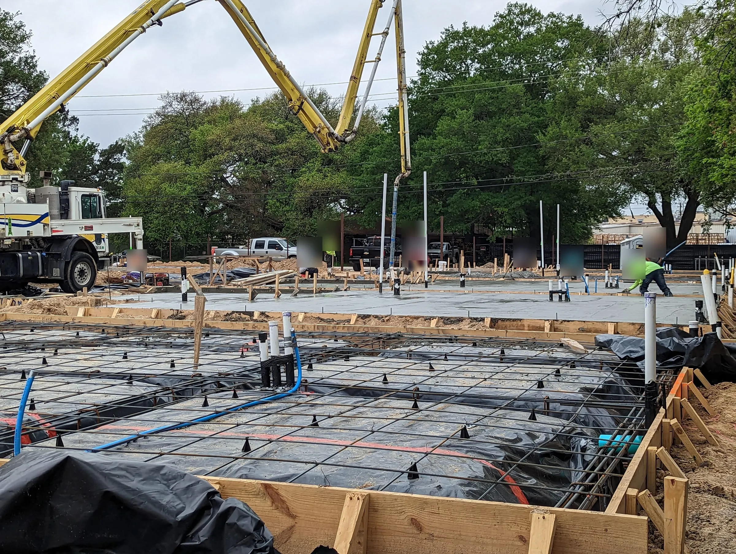 Slab foundation forms with rebar during a concrete pour